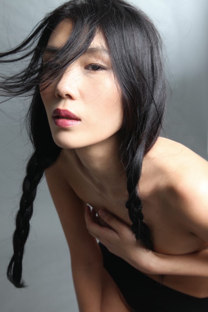 Korean model with perfect skin, rose lips, and braids, shot by Wade Shields